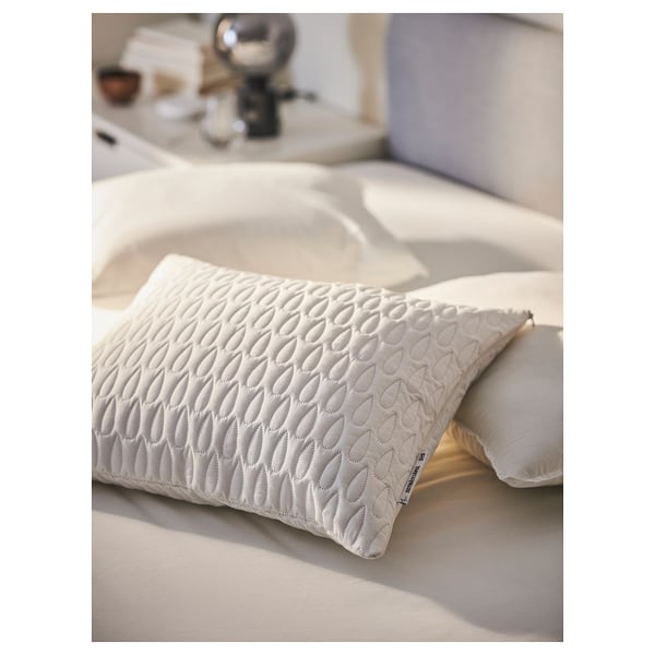 Bed with white SOTNÄTFJÄRIL pillow protector, patterned, with waterproof layer, soft wadding.