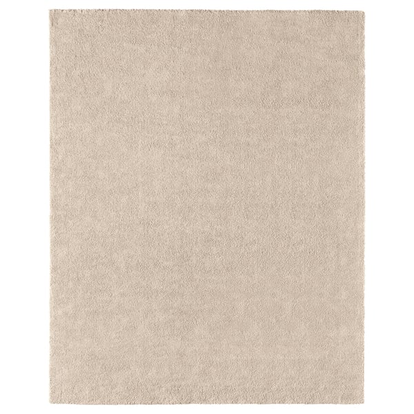A beige STOENSE rug. Its rectangular, made of polypropylene with a soft, low pile. Ideal for various floors, it dampens sound and is easy to care for.