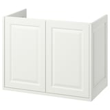 A white TÄNNFORSEN bathroom cabinet with bevelled panels, two doors, and a classic design.