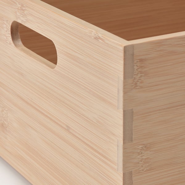 Wooden box with cut-out handle, smooth finish. Made from bamboo, durable and functional.
