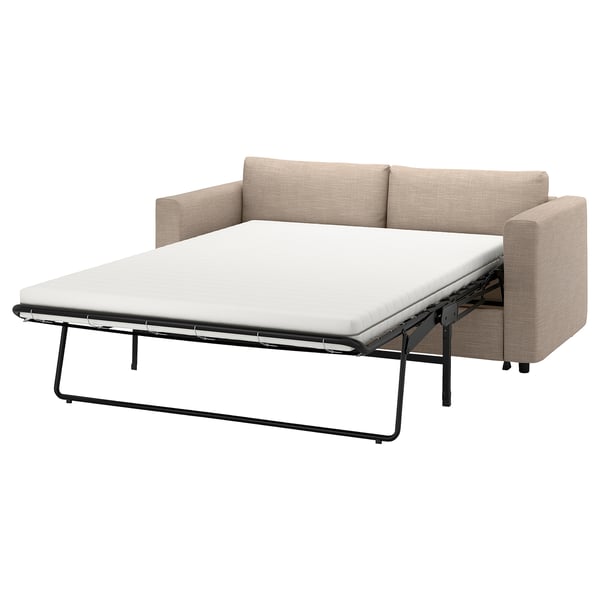 An ikea VIMLE beige fabric sofa-bed in a modern design, with a white mattress pulled out.