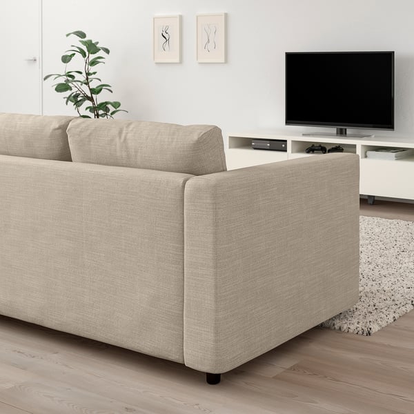 Beige VIMLE sectional sofa in living room with tv, rug, and plant.