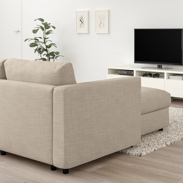 Modern living room with VIMLE sofa in beige. Sofa fits well under white tv stand, near potted plant. Grey and white rug below.