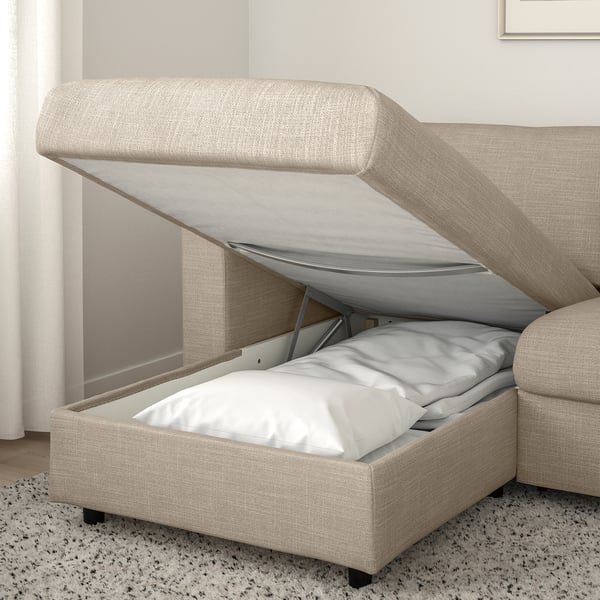A beige VIMLE sofa with a storage chaise. The seat lifts open revealing cushions and a chamber for storage.