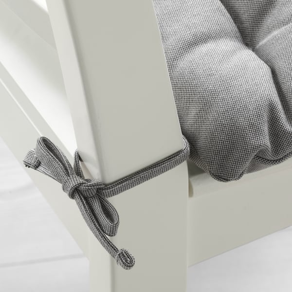 A cushioned chair pad with ties, featuring reversible fabric for comfort and easy cleaning.