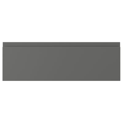 A VOXTORP drawer front in dark grey, featuring a sleek, minimalist design with integrated handles.
