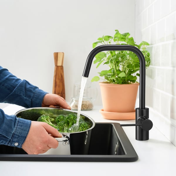 Washing broccoli in kitchen, conserving water and energy.