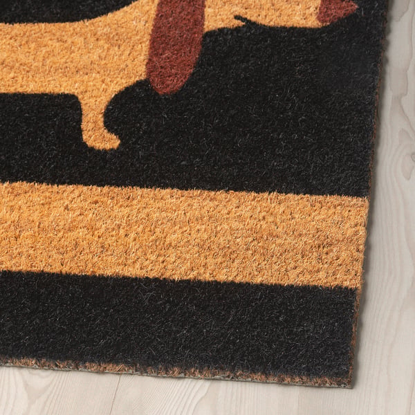 Doormat with detailed dog prints, crafted from coir fibre, featuring vibrant black and brown stripes.
