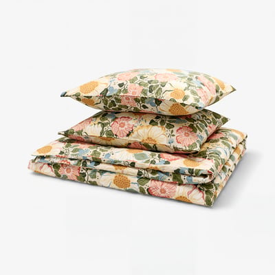 An ARENBOK duvet cover set with beige and colourful floral designs, neatly folded using soft sateen-woven cotton and lyocell blend material.