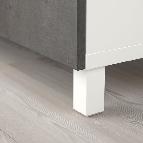 Clean, modern furniture leg, showing sturdy white support underneath light wooden floor.