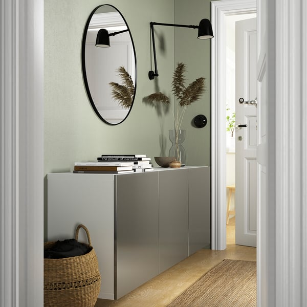 Grey BESTÅ cabinet with mirror and dried flowers in hallway.