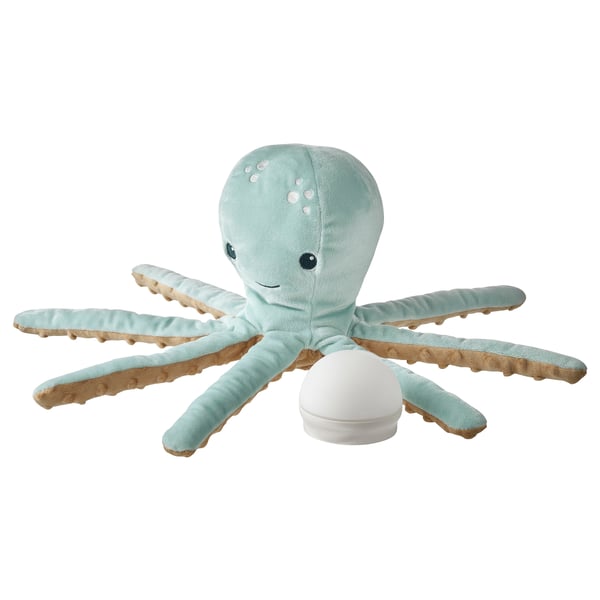Octopus-shaped lamp in light blue soft fabric, 8 tentacles, eyes black, silver sucker dots, white light source body, cosy and child-friendly.