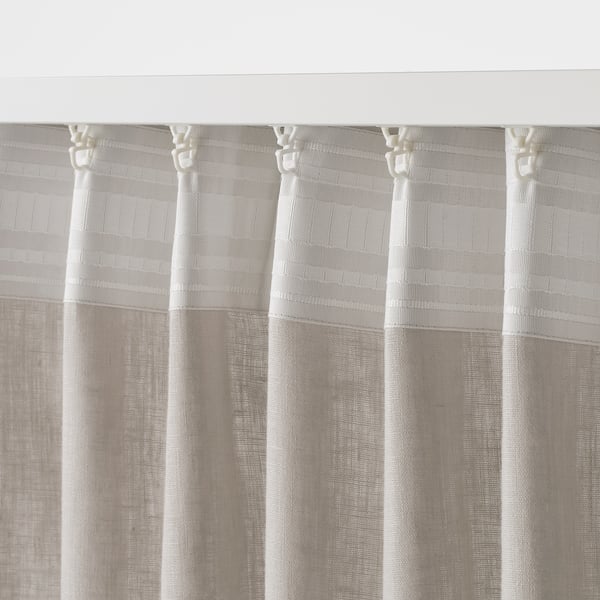 Sheer linen curtains with textured weave, daylit privacy, adjustable hem.