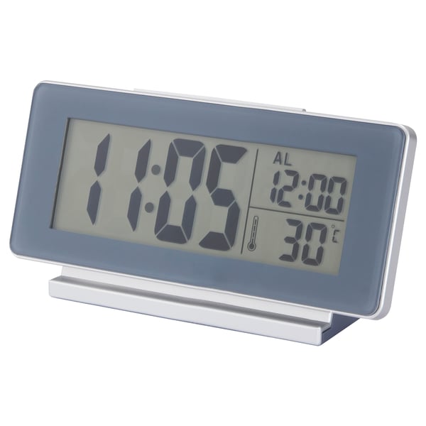 A FILMIS digital clock in silver with led backlight, displaying time, alarm, and temperature.