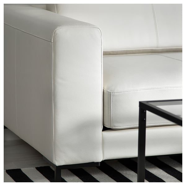 Modern white leather sofa, sleek design, metal legs.