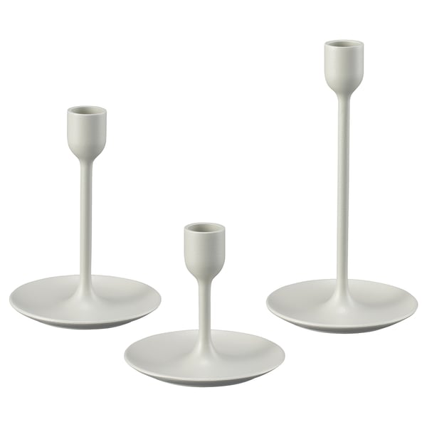 Three white candlesticks in varying heights; modern design, metal body with felt bases.