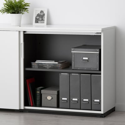 White GALANT cabinet with 2 shelves, combo lock, grey boxes, files, plant, photo.