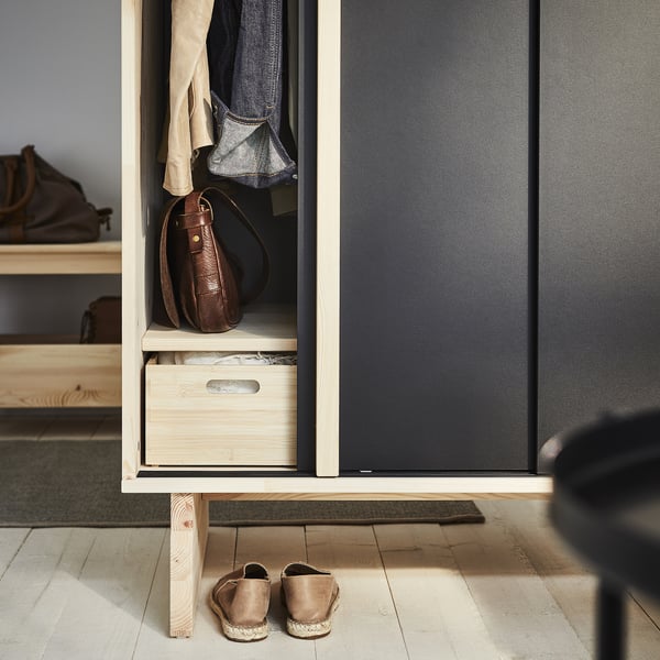 GLAMBERGET wardrobe, beige with black accents, wood material. Store bags and clothes neatly. Shoes placed below.