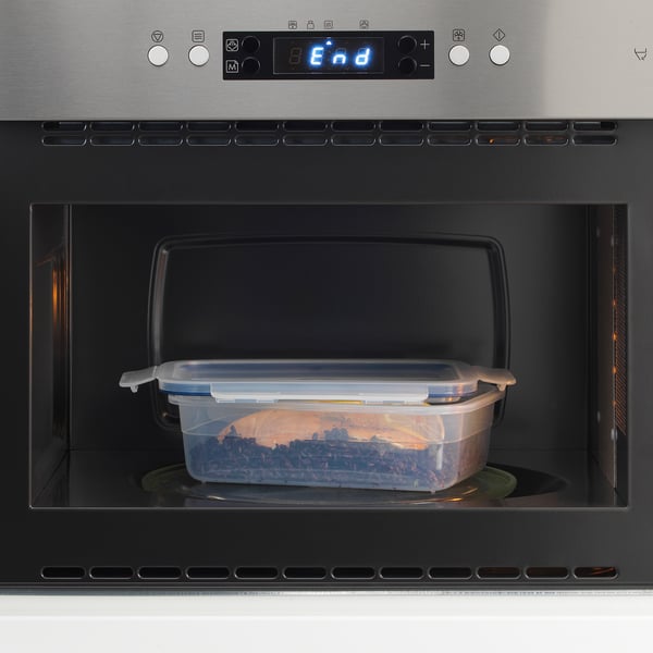 Microwave-safe container with snap-lock lid inside a microwave, showing its designed for leak-proof, secure food storage.