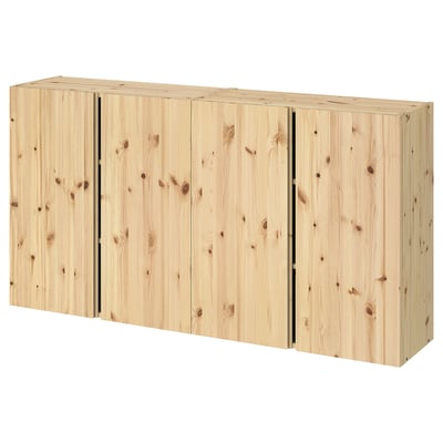 A light-colored wooden IVAR storage unit. Its rectangular, with three sections and adjustable shelves, made of solid pine.