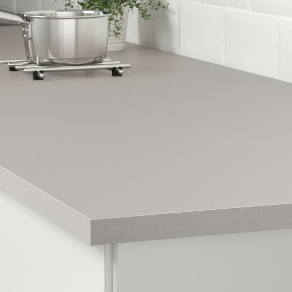 Grey laminate kitchen worktop, easily cleaned and maintained. Supports are visible underneath.