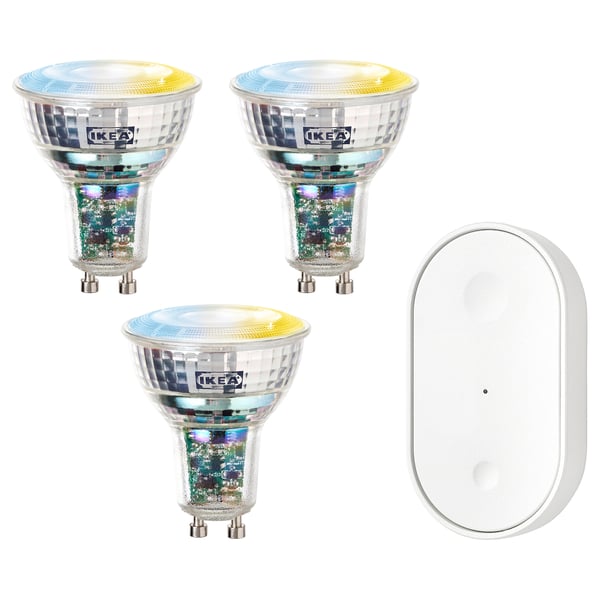 Three colorful ikea smart bulbs and a white remote control.