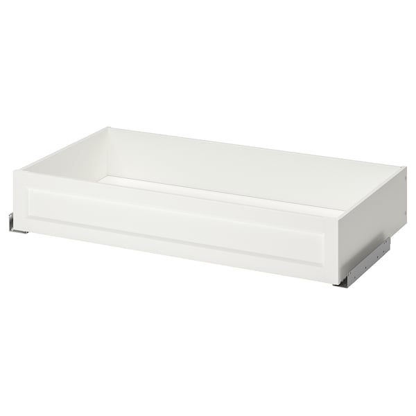 A white KOMPLEMENT framed drawer. It is rectangular with a smooth, flat surface. The drawer is designed for use in a pax wardrobe system.