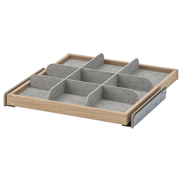 A wooden pull-out drawer organiser with grey fabric compartments for storage.