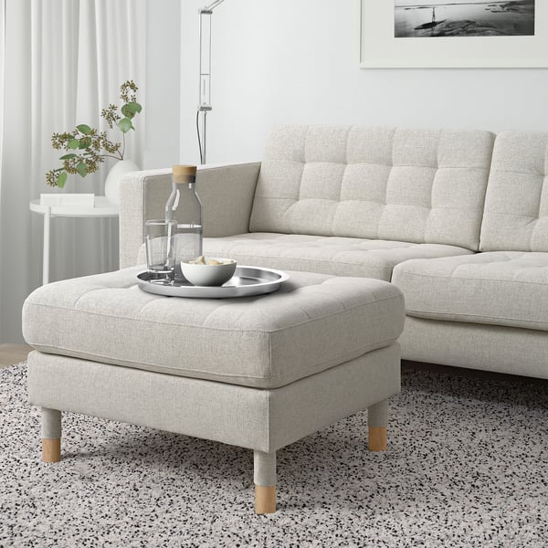 Modern living room with grey LANDSKRONA sofa & footstool. Tray with glasses and bowl. Cosy, minimalist decor.