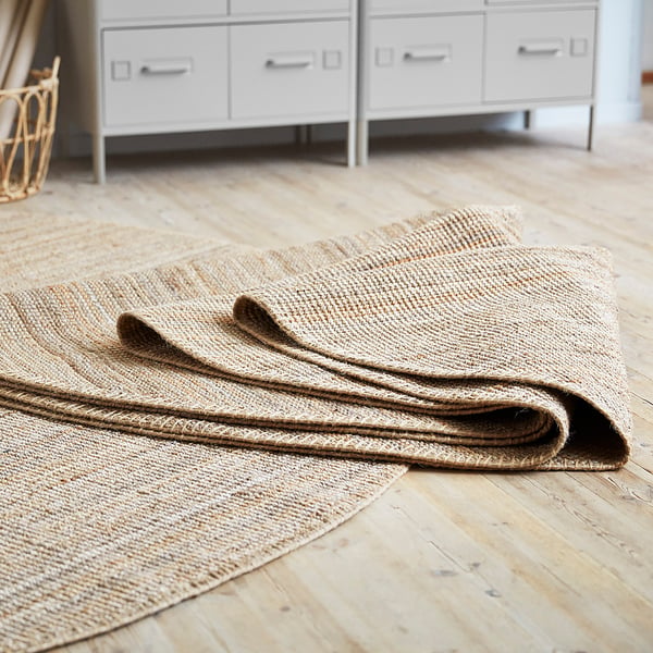 LOHALS rug, natural jute, flatwoven, on wood floor.