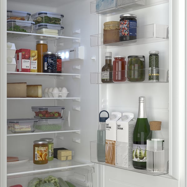 Fridge with adjustable shelves, organised food items, and led light inside, showing clean and neat storage.
