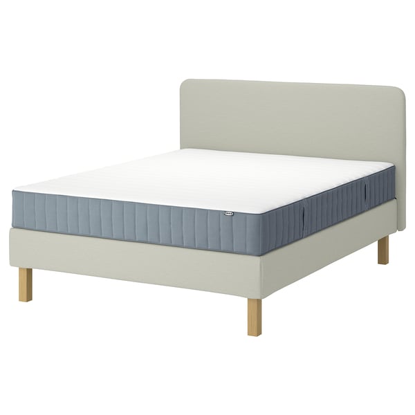 LYNGÖR bed: cream base, grey mattress, wooden legs, soft headboard.