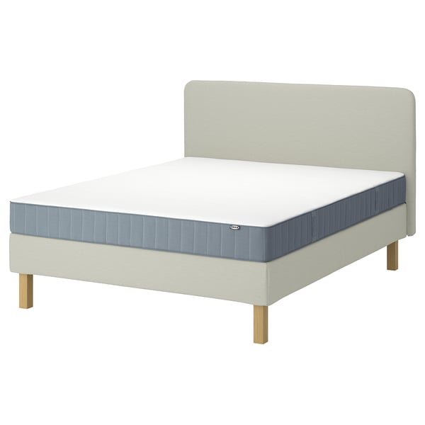LYNGÖR bed set in beige with grey-blue mattress on wooden legs, plush headboard.