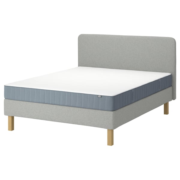 Light grey LYNGÖR upholstered bed set. A soft headboard, flat slats base, and a pocket-sprung mattress on light wooden legs.