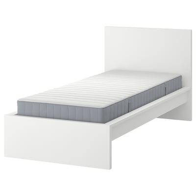 A white MALM bed with a gray mattress. The bed has a modern, minimalist design with a high headboard. It is shown without any bedding.