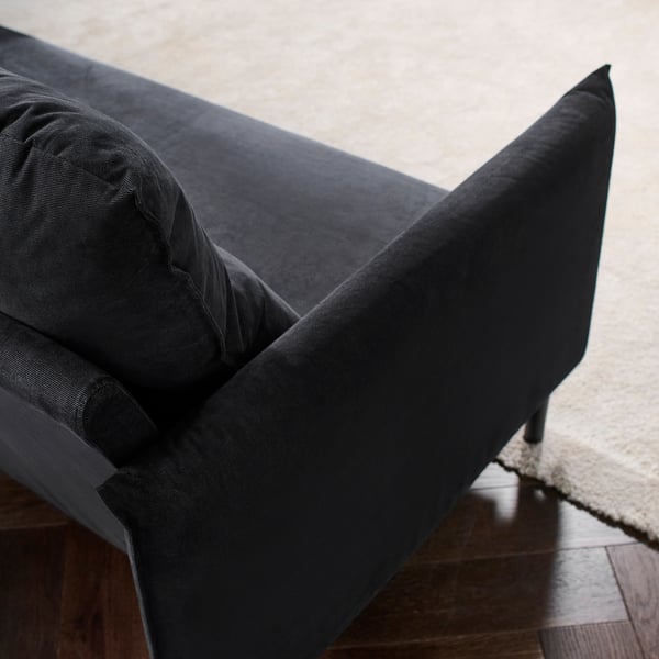 Dark grey sofa with sleek design, supportive cushions, and notable stitching detail.