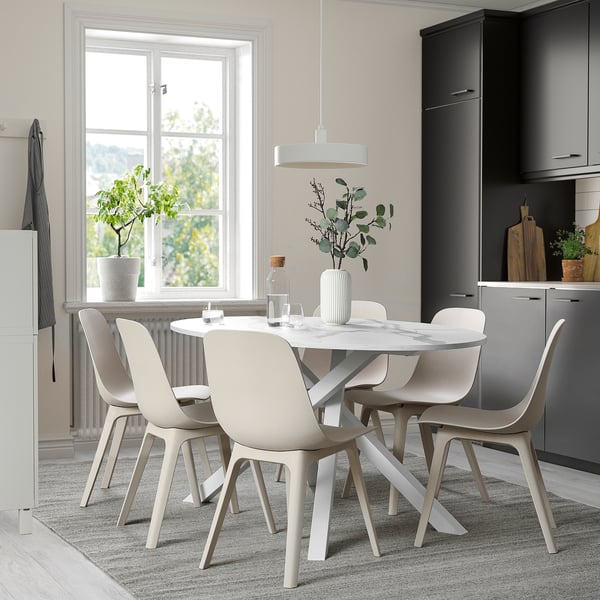 Modern dining setup with table, 4 chairs, and plants.