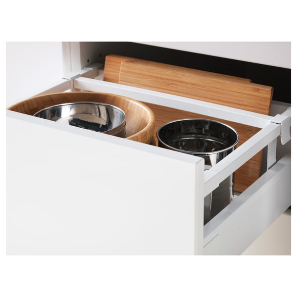 White kitchen drawer fully extended showing stainless steel bowls and wooden cutting boards, demonstrating its full accessibility and organisation.