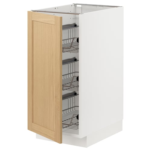 Open white kitchen cabinet with oak door and pullout shelves.
