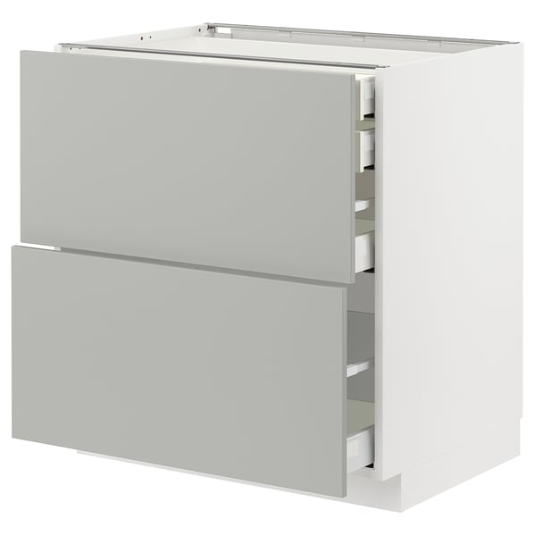 Modern white METOD kitchen unit. Light grey drawers, rectangular, with sleek design.