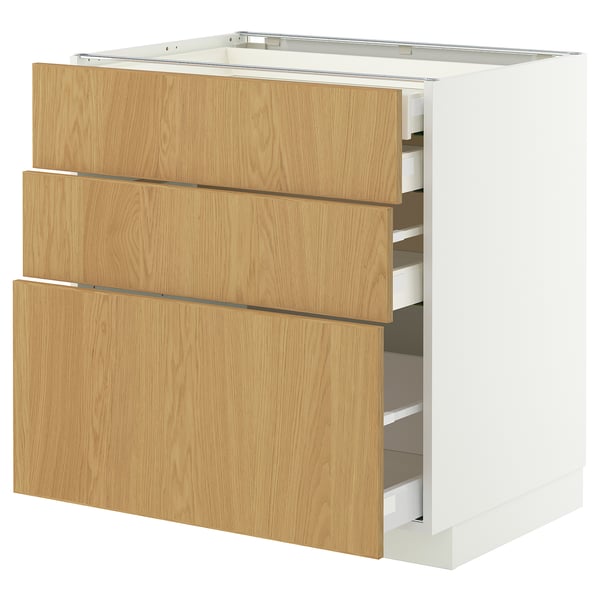 New METOD kitchen cabinet in light wood colour, white frame, featuring three drawers with sleek design and smooth finish.