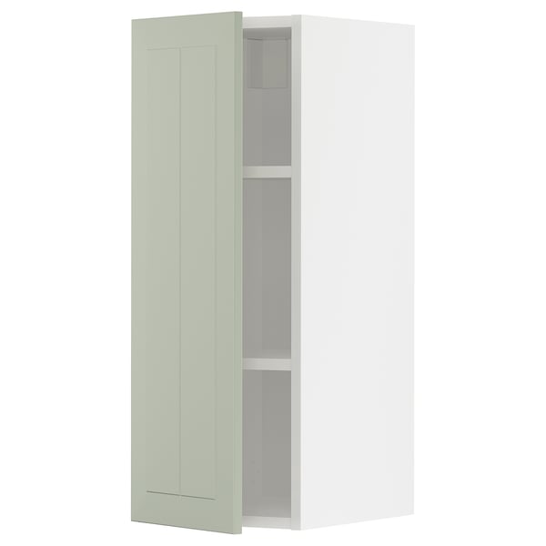 Modern kitchen cabinet in light green with minimalist design, two shelves, and white interior.