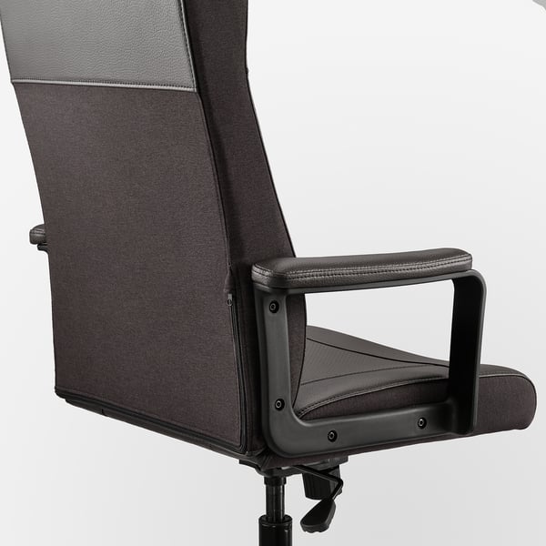 A close-up of a modern office chair. It a high backrest, padded armrests, and a sleek design.