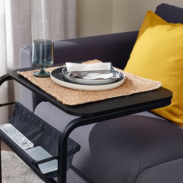 A multi-functional side table with a tabletop that slides over ones lap, perfect for eating while watching tv. Attached pouch holds remote and phone.