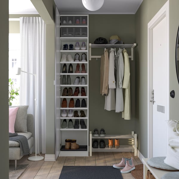 A modern entryway closet with a shoe rack, coat hooks, and shelves for organised storage.