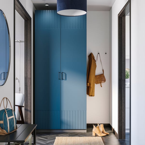 Deep blue PAX wardrobe with yellow coat, brown bag, and beige boots. Modern, sleek design.