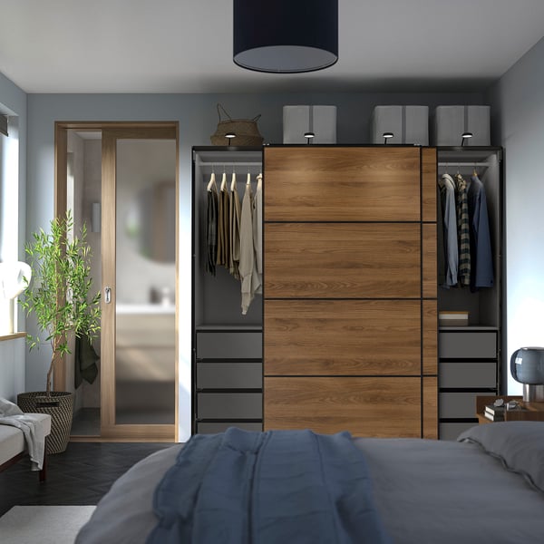 Modern bedroom with PAX wardrobe, sliding doors, lighting, and adjustable feet.