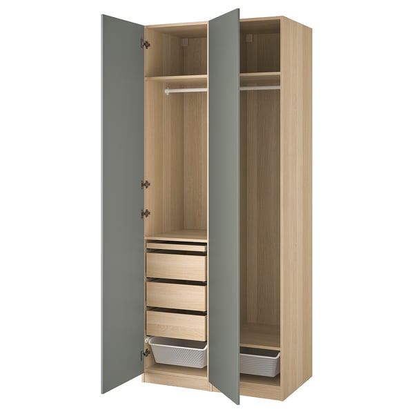 An open light brown PAX wardrobe with blue doors, featuring shelves, drawers, and a clothes rail.