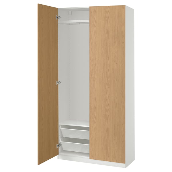 An open PAX wardrobe in white with wooden doors. It shelves and a hanging rod inside.