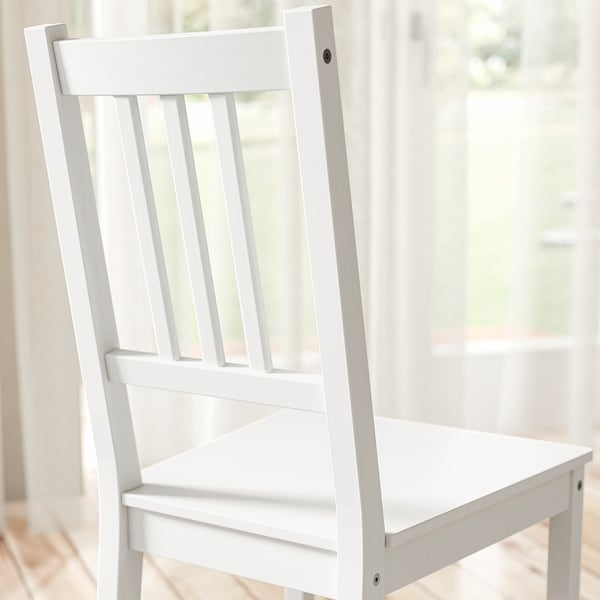 Simple white wooden chair, clean design.